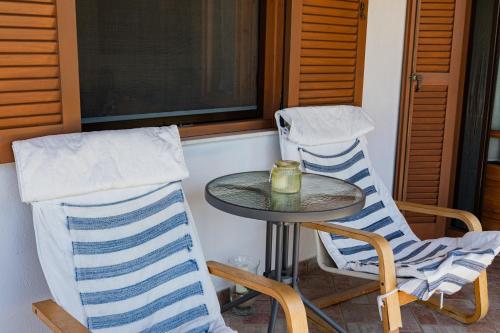 a table and two chairs on a porch at Family House by the Sea in Nikiti