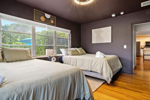 een slaapkamer met twee bedden en een raam bij Game Room Pool Fun, Close To Downtown Life in West Palm Beach
