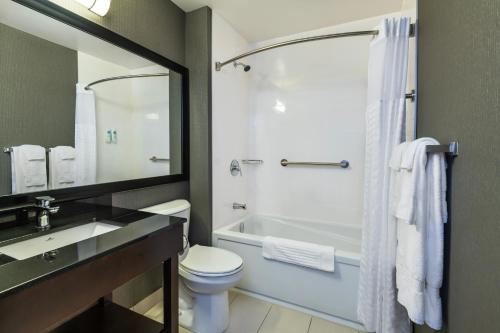 a bathroom with a sink and a toilet and a shower at Comfort Inn in Laval