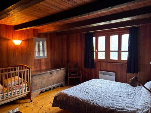 a bedroom with a bed and a crib in it at Ca da Viola in Cavagnago