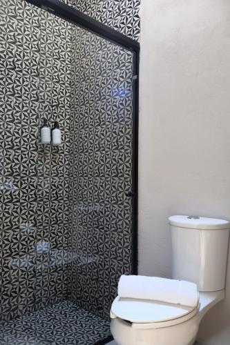 a bathroom with a shower with a toilet at Hacienda Álamos in Laborcillas