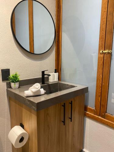 a bathroom with a sink and a mirror at Hacienda Álamos in Laborcillas