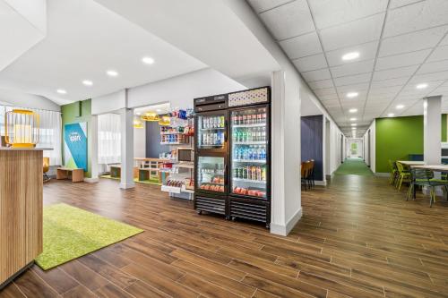 a store with a drink cooler in the middle of a room at Spark by Hilton Wilkes Barre in Wilkes-Barre