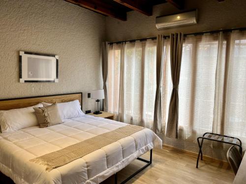 a bedroom with a bed and a large window at Hacienda Álamos in Laborcillas