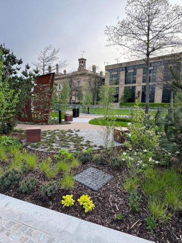 a garden with flowers in front of a building at James Clow Bed & Breakfast in Belfast