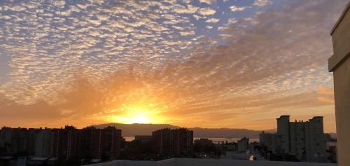 a sunset over a city with clouds at Ático Sol & Mar - La Línea in La Línea de la Concepción