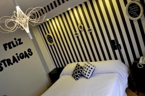 a bedroom with a bed with two pillows on it at Santa Rosa Hotel in Olavarría