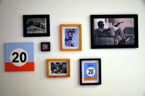 a wall with framed pictures on a wall at Santa Rosa Hotel in Olavarría