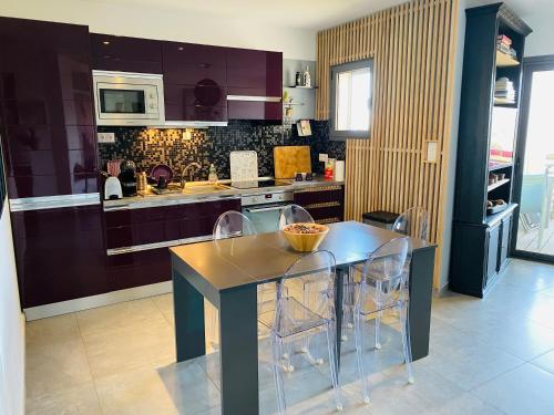a kitchen with a dining table and chairs in it at Appartement 74 cita Di sali in Porto-Vecchio