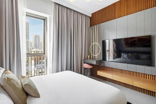 a hotel room with a bed and a large window at Serene Haven Cozy Community Courtyard View in Dubai