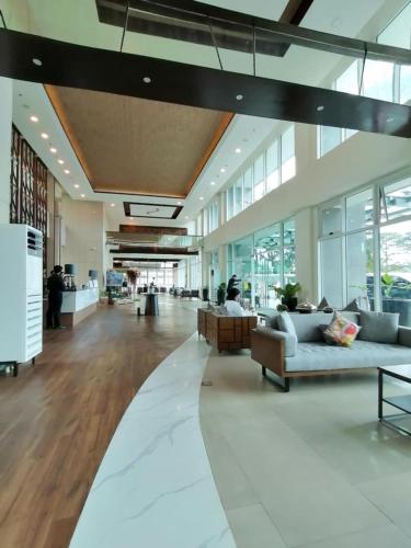 a lobby with couches and tables in a building at Condo 604 Baguio retreat with pool and gym in Baguio