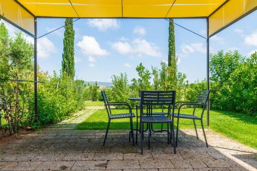 a table and chairs sitting under a tent at AGRITURISMO 8e28 CAPALBIO in Nunziatella