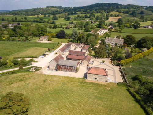 an aerial view of a large house in a field at Hayes Farm - 8 Houses in Gloucester