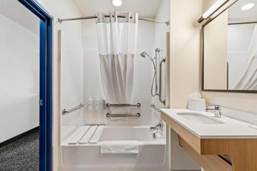 a bathroom with a shower and a sink at Spark by Hilton Wilkes Barre in Wilkes-Barre