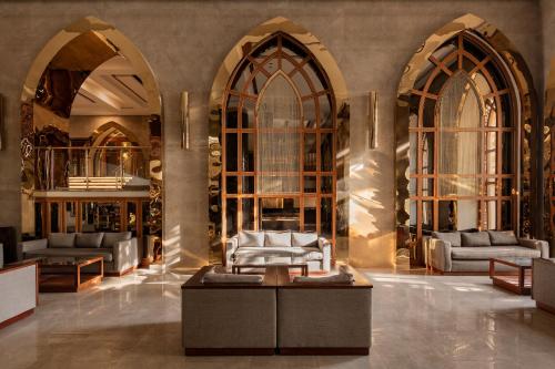a lobby with three arched windows and a couch at The Grand Hotel Sharm El Sheikh in Sharm El Sheikh