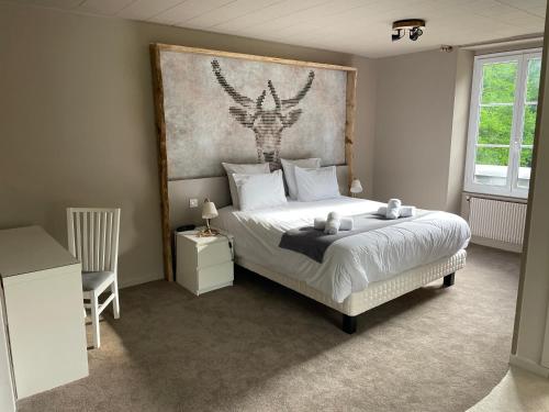 a bedroom with a bed with a large headboard at Le Tronçais in Saint-Bonnet-Tronçais