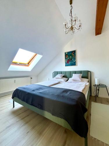 a bedroom with a large bed with a chandelier at Zieleckblick in Bad Sooden-Allendorf