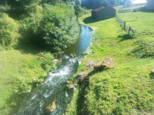 an aerial view of a small river in a field at Zew Natury in Skorka