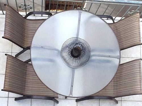 a table with a fan on top of it at MANDO PATRASSO - Clasical apartment in the center of Patras with free parking in Patra