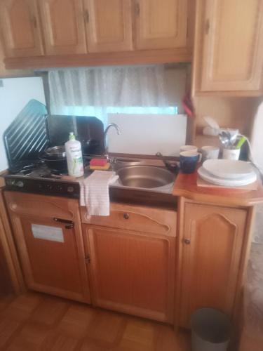 a kitchen with a sink and a stove top oven at Zew Natury in Skorka