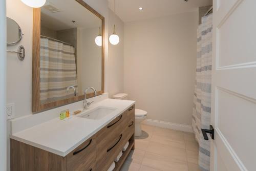 a bathroom with a sink and a toilet at La Maison Kent - Par Aneyro in Quebec City