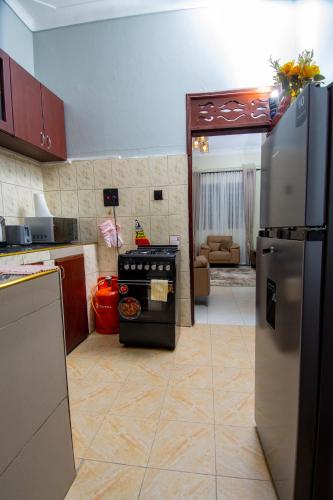 a kitchen with a stove and a refrigerator at Urban Oasis located at Kyebando Nsooba in Kyebando