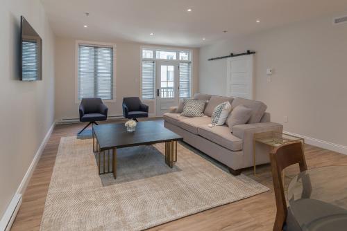 a living room with a couch and a table at La Maison Kent - Par Aneyro in Quebec City