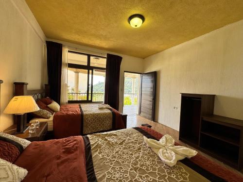 a hotel room with two beds and a fireplace at Hotel Mercy in San Juan La Laguna