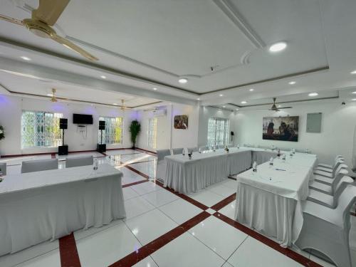 a large room with tables and chairs in it at Park Springs Hotel in Cape Coast