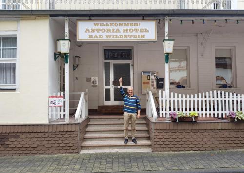 a man standing on steps in front of a building at Astoria Hotel in Traben-Trarbach in Traben-Trarbach