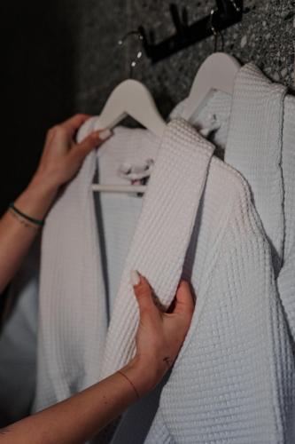 a woman is holding up a white bedsheet at Arkadia Beach Hotel in Odesa