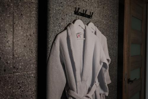 a white sweater hanging on a wall at Arkadia Beach Hotel in Odesa