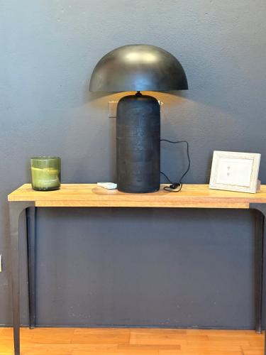 a lamp sitting on top of a wooden table at CASA VASARI Holiday Suites TUSCANY in Lucignano