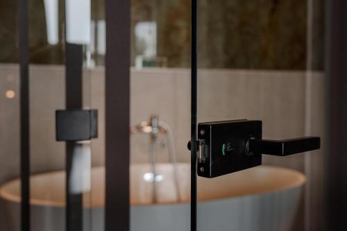 a bathroom with a sink and a bath tub at Arkadia Beach Hotel in Odesa