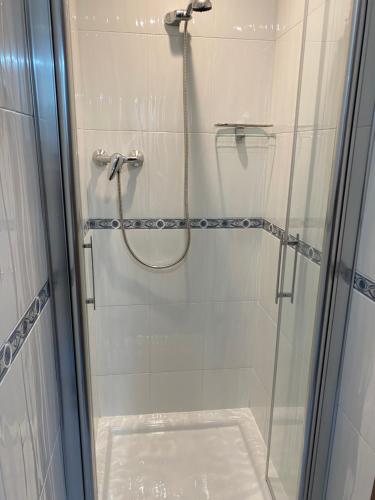 a bathroom with a shower with a glass door at Apartamento El Puerto III-Finisterre in Fisterra