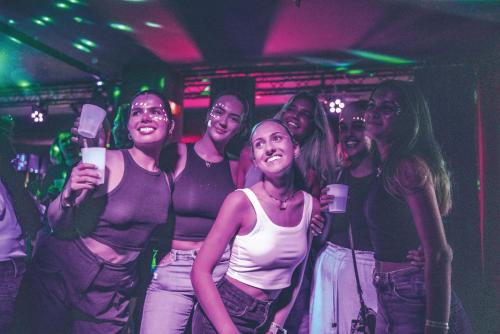 a group of people posing for a picture in a club at YellowSquare Florence in Florence
