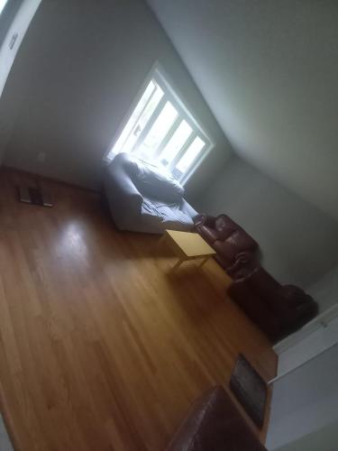 an overhead view of a living room with a window at Homestay Near Victoria Park- FREE WIFI & PARKING-TOP LOCATION in Kitchener