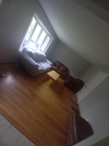 a living room with a couch and a window at Homestay Near Victoria Park- FREE WIFI & PARKING-TOP LOCATION in Kitchener