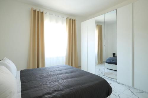 a bedroom with a bed and a large mirror at Free Parking Elmi - due passi dal Lago Maggiore in Arona