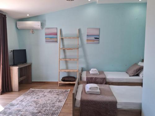 a room with two bunk beds and a ladder at Blue Waves in Vlorë
