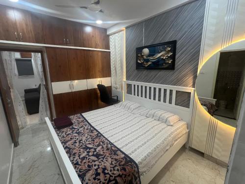 a bedroom with a bed and a painting on the wall at Atlas Homes 1BHK HomeStays in Hyderabad