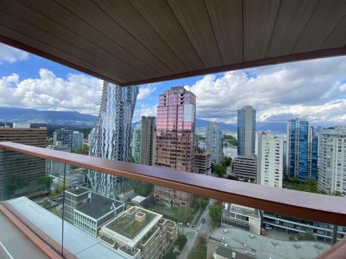 a view of a city from a window in a building at Brand New Modern 2 BR Condo in Heart of Downtown Vancouver in Vancouver