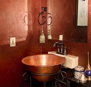 a bathroom with a copper sink and a mirror at El Morocco Inn & Spa in Desert Hot Springs