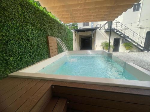 a hot tub with a fountain in a garden at Solmi Rooms in Calero