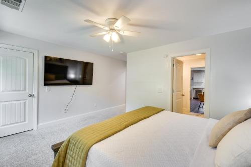 a white bedroom with a bed and a ceiling fan at Walk to Main Street Shops Helen Escape with Balcony in Helen