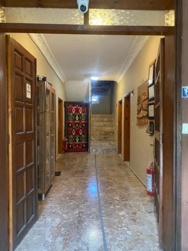 an empty hallway with doors and stairs in a building at Rosemary Pansiyon in Cıralı