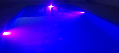 a pair of blue and red lights on a bed at Camels House in Merzouga