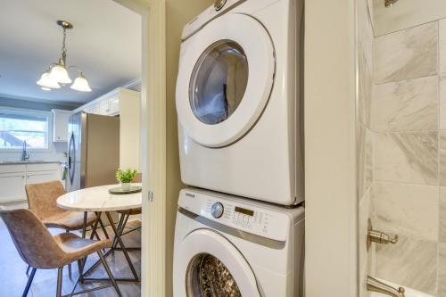 a washer and dryer in a kitchen with a table at Walk to Main St and River Downtown Helen Condo in Helen