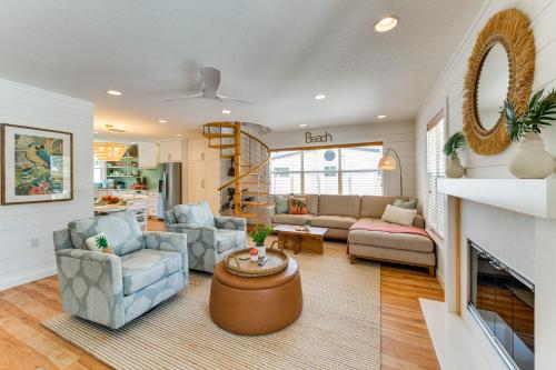 a living room with a couch and a fireplace at Walk to Gulf Luxe Luau-Themed Gem in Holmes Beach in Holmes Beach