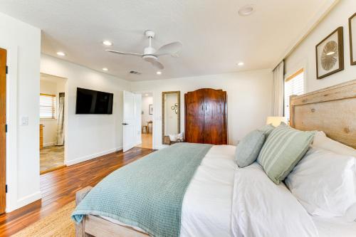 a bedroom with a bed and a ceiling fan at Walk to Gulf Luxe Luau-Themed Gem in Holmes Beach in Holmes Beach